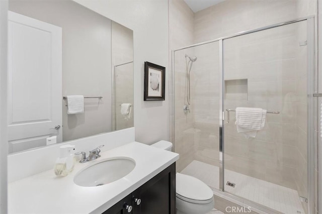 bathroom featuring vanity, toilet, and walk in shower