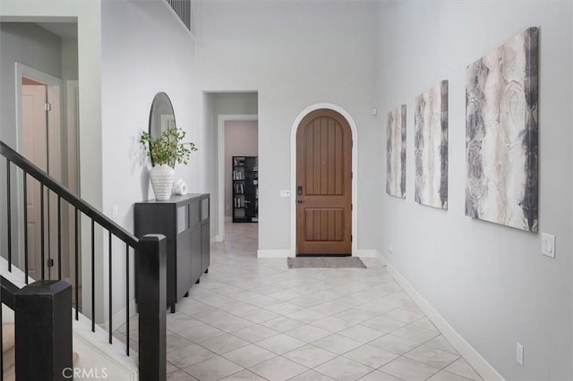 entrance foyer featuring a high ceiling and light tile patterned flooring