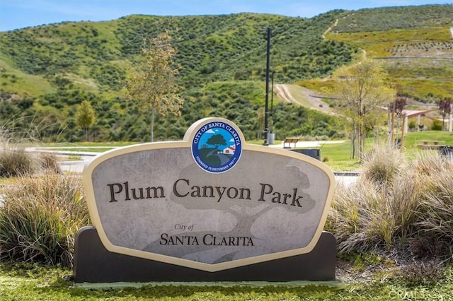 community / neighborhood sign with a mountain view