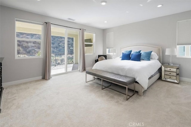 bedroom featuring light carpet and access to outside