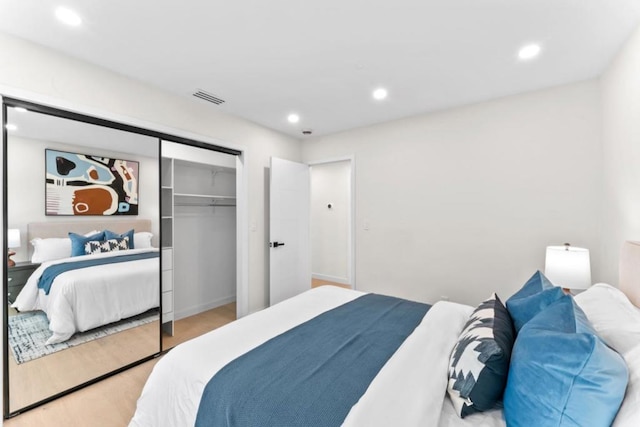 bedroom featuring hardwood / wood-style flooring and a closet