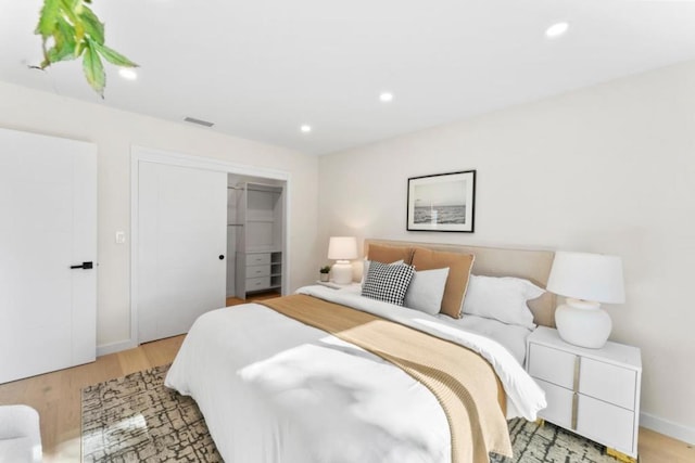 bedroom featuring a closet and light wood-type flooring