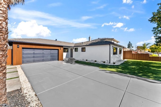 ranch-style home featuring a front yard and a garage