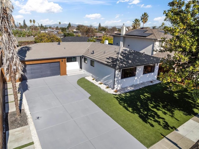 view of front of house with a garage and a front lawn