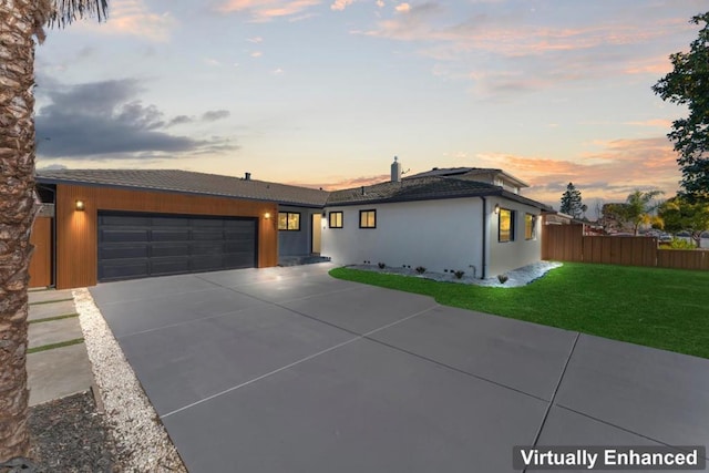 view of front of property with a lawn and a garage