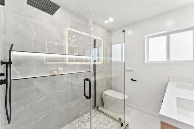 bathroom featuring vanity, toilet, and an enclosed shower