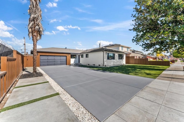 single story home featuring a garage and a front lawn