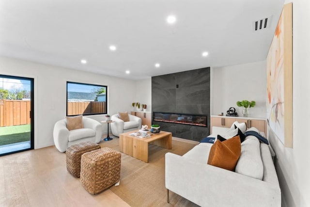 living room with a fireplace and light hardwood / wood-style floors