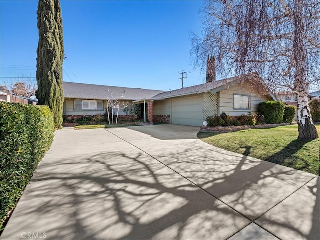 ranch-style home with a garage and a front yard