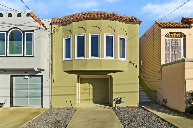 mediterranean / spanish house with a garage