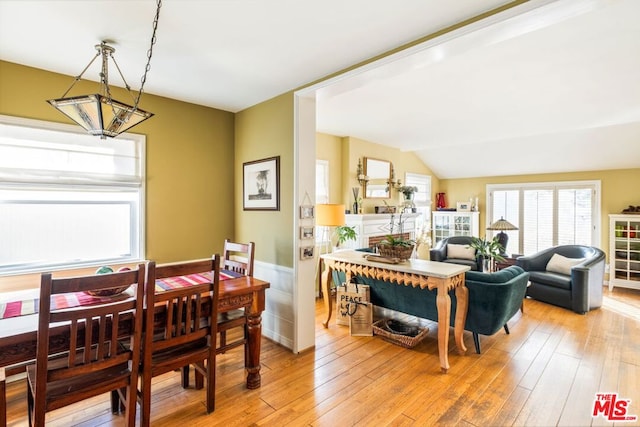 dining area featuring light hardwood / wood-style flooring and vaulted ceiling