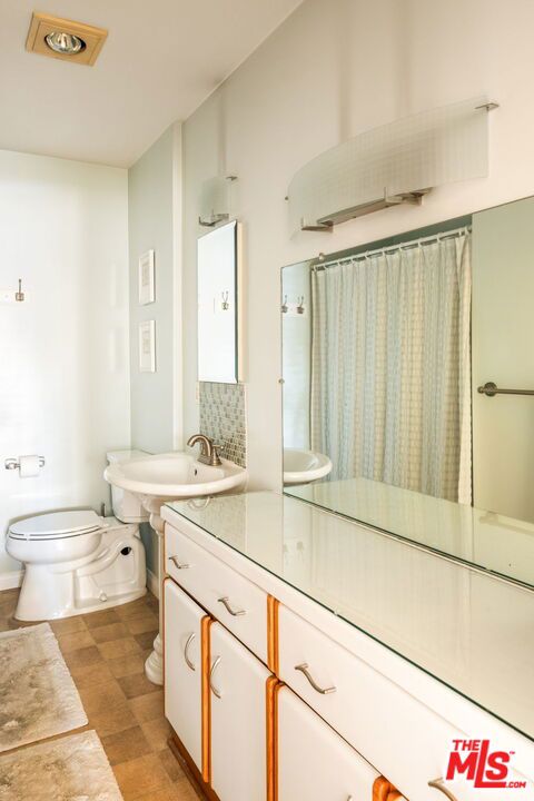 bathroom with sink, hardwood / wood-style floors, and toilet