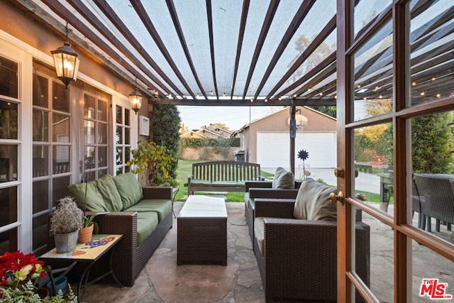 view of patio featuring a garage, an outdoor hangout area, and an outdoor structure