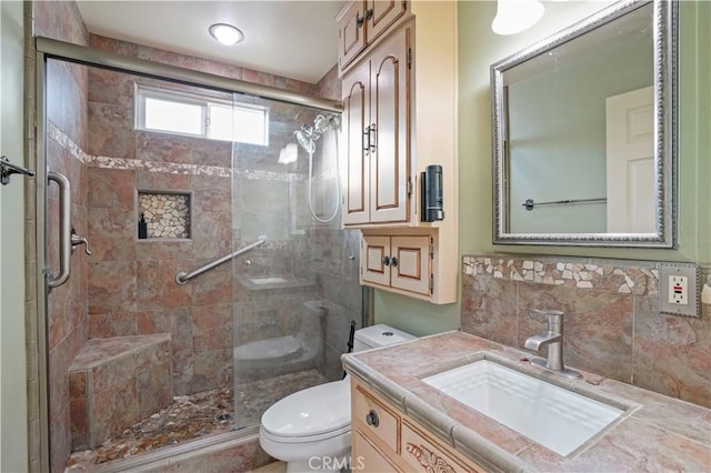 bathroom with toilet, a shower with shower door, and vanity