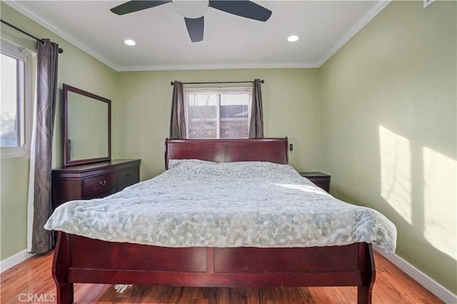 bedroom featuring ceiling fan, crown molding, and wood-type flooring