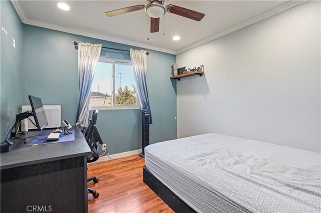 bedroom featuring ceiling fan, hardwood / wood-style floors, and crown molding