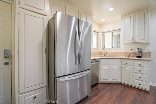 kitchen with sink, white cabinets, and appliances with stainless steel finishes