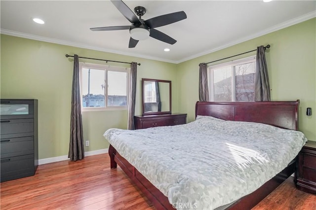 bedroom featuring crown molding, hardwood / wood-style flooring, and ceiling fan