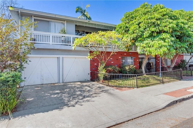 view of front of house featuring a balcony and a garage