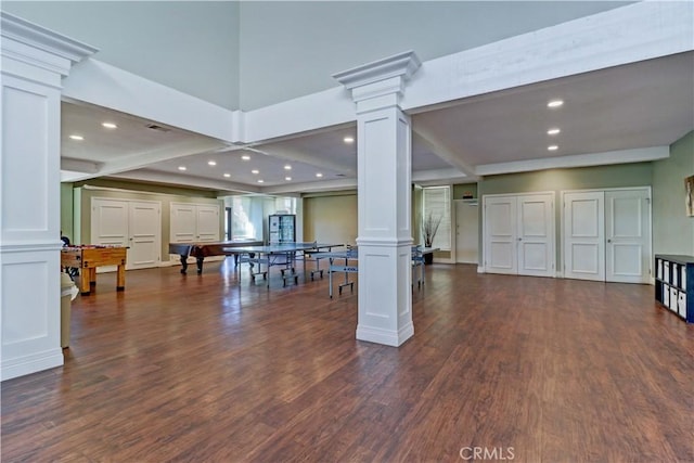 living room featuring decorative columns and dark hardwood / wood-style floors