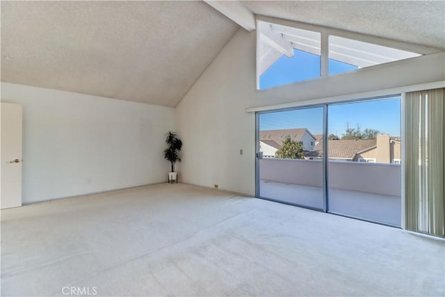 interior space with light colored carpet, a textured ceiling, and lofted ceiling with beams