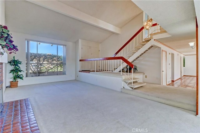 unfurnished living room featuring carpet flooring and vaulted ceiling with beams