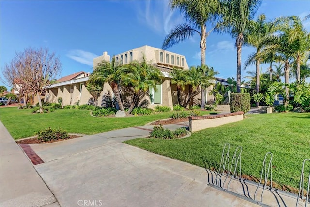 mediterranean / spanish house featuring a front lawn