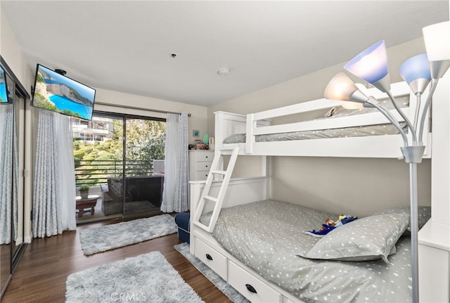 bedroom with access to exterior and dark hardwood / wood-style flooring