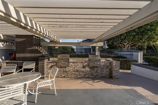 view of patio / terrace featuring exterior kitchen, grilling area, and a pergola