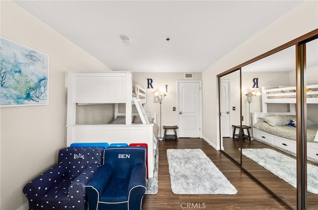 bedroom with a closet and dark hardwood / wood-style floors