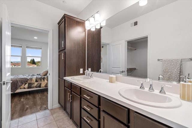 bathroom with tile patterned flooring and vanity