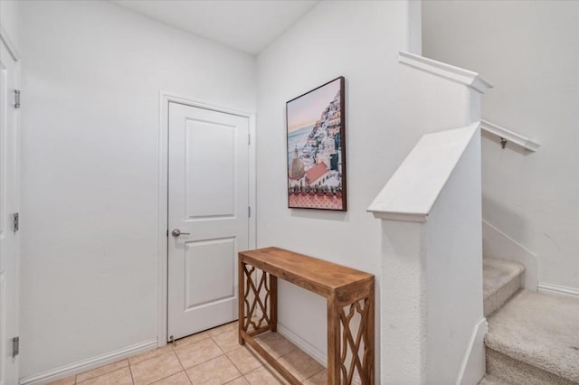 hall featuring light tile patterned floors