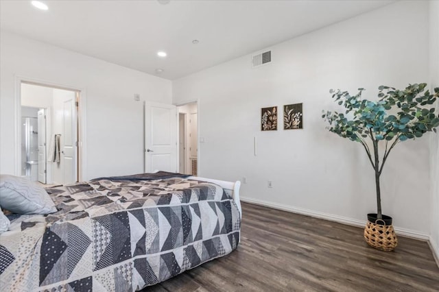 bedroom with ensuite bathroom and dark hardwood / wood-style floors