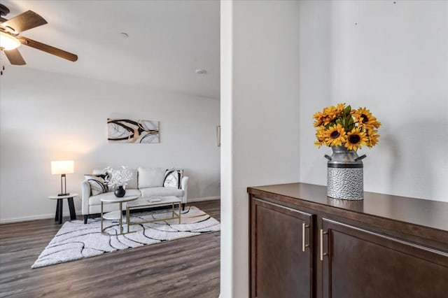 living room with dark hardwood / wood-style floors and ceiling fan