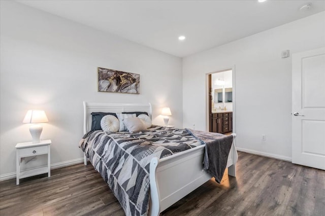 bedroom featuring dark hardwood / wood-style floors and ensuite bathroom