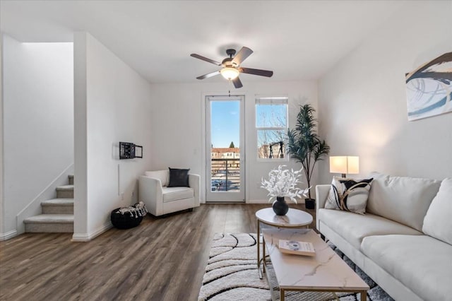 living room featuring dark hardwood / wood-style flooring and ceiling fan