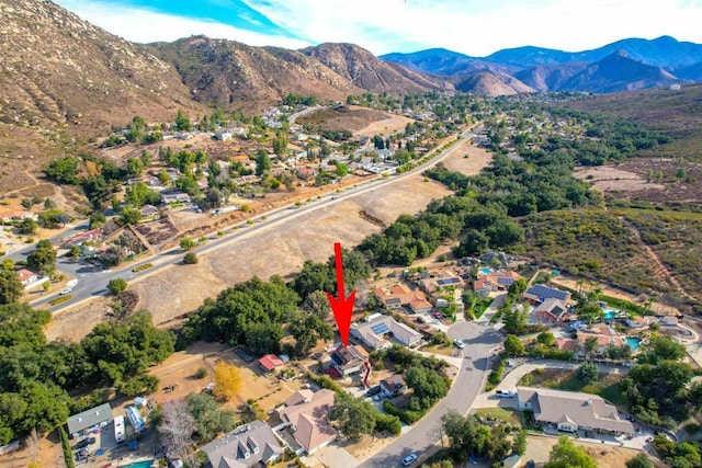 birds eye view of property featuring a mountain view