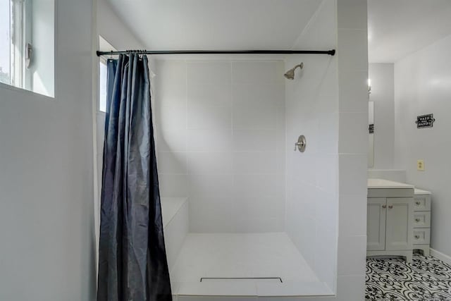 bathroom featuring vanity and curtained shower