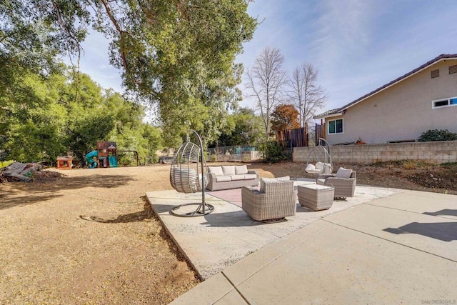 view of patio featuring a playground and an outdoor hangout area