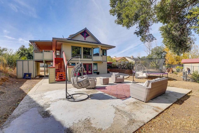 exterior space with outdoor lounge area, a patio, and a trampoline