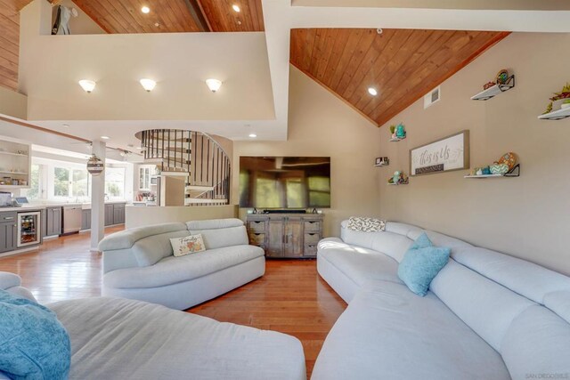 living room featuring light hardwood / wood-style flooring, high vaulted ceiling, beverage cooler, and wood ceiling