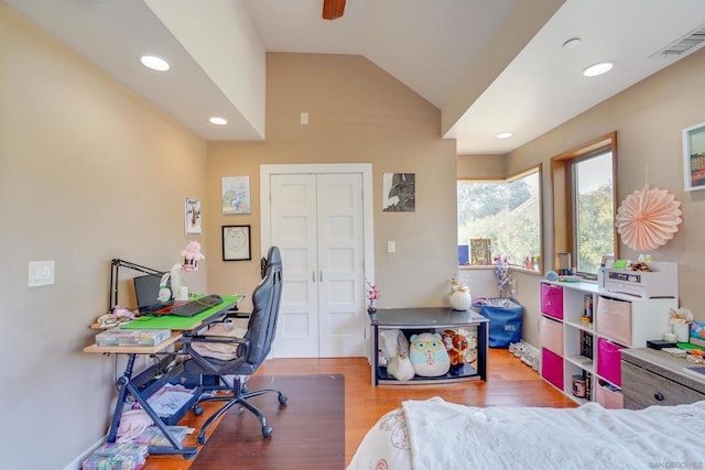 bedroom featuring a closet, vaulted ceiling, and hardwood / wood-style flooring