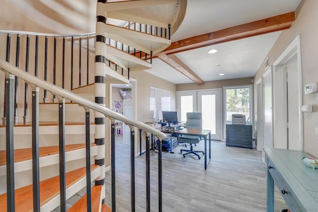 office space with beam ceiling and light hardwood / wood-style flooring