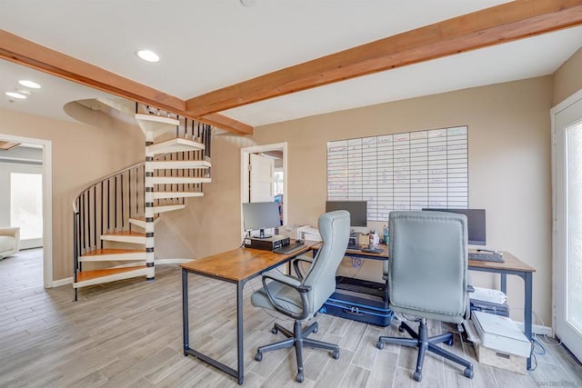 office area with light hardwood / wood-style floors and beam ceiling