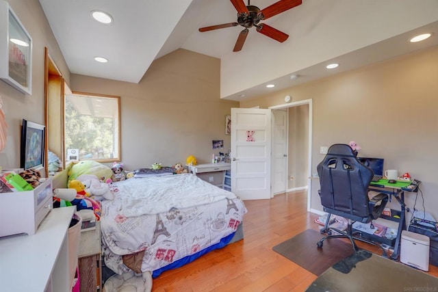 bedroom with ceiling fan, vaulted ceiling, and wood-type flooring