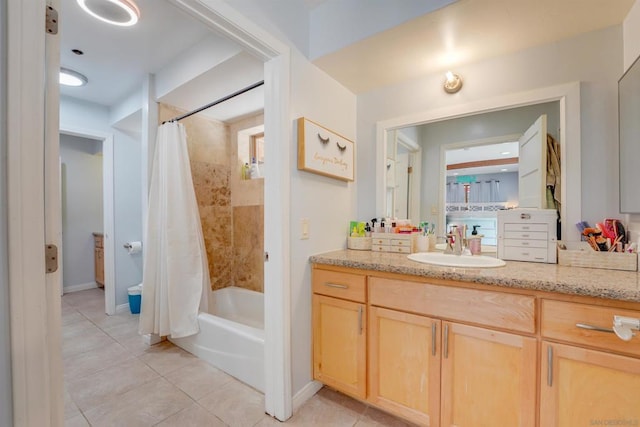 bathroom featuring shower / bath combo with shower curtain, tile patterned floors, and vanity