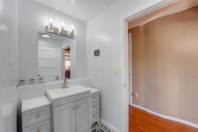 bathroom with hardwood / wood-style floors and vanity