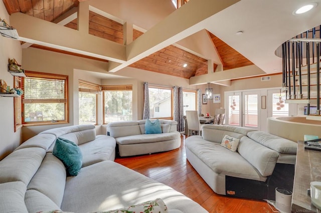 living room with high vaulted ceiling, beamed ceiling, light hardwood / wood-style floors, and wooden ceiling