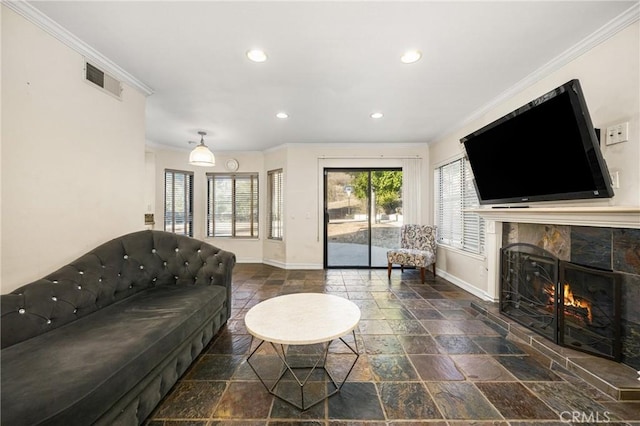 living room with crown molding and a fireplace