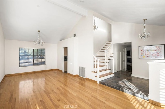 unfurnished living room featuring beamed ceiling, an inviting chandelier, hardwood / wood-style floors, and high vaulted ceiling